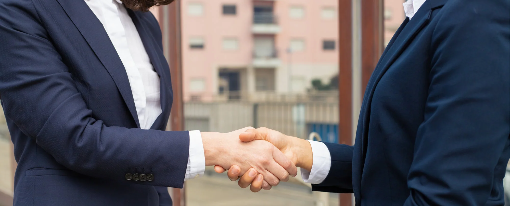 two men in suits shaking hands